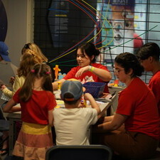 a volunteer leads kids through an activity