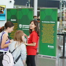 A volunteer smiles at the welcome booth