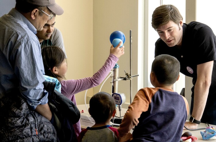 Graduate students Gokul Subraveti and Nicholas Wilkins demonstrate their pressure swing adsorption testing apparatus -- and balloons. 