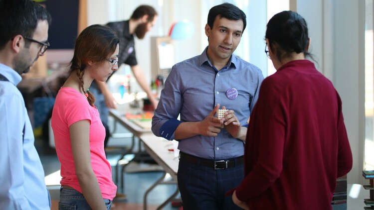 Alireza Rangriz Shokri explains his work to fellow researchers with the U of A's Future Energy Systems, using a 3D printed cube to explain how CO2 and brine can be used to fill in gaps in underground formations of porous rock.