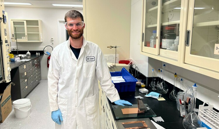 PhD candidate Jasper Woodard prepares electrodes for lithium ion batteries in the lab. Woodard is working on ways to improve the batteries so they last longer between charges — an advance that would be significant as electric vehicles grow in popularity.