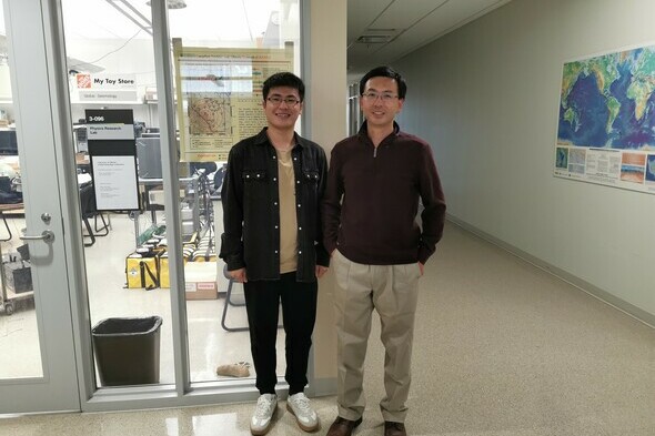 Dr. Jingchuan Wang (left) with Dr. Jeffery Gu (right) stand in a hallway at the University of Alberta