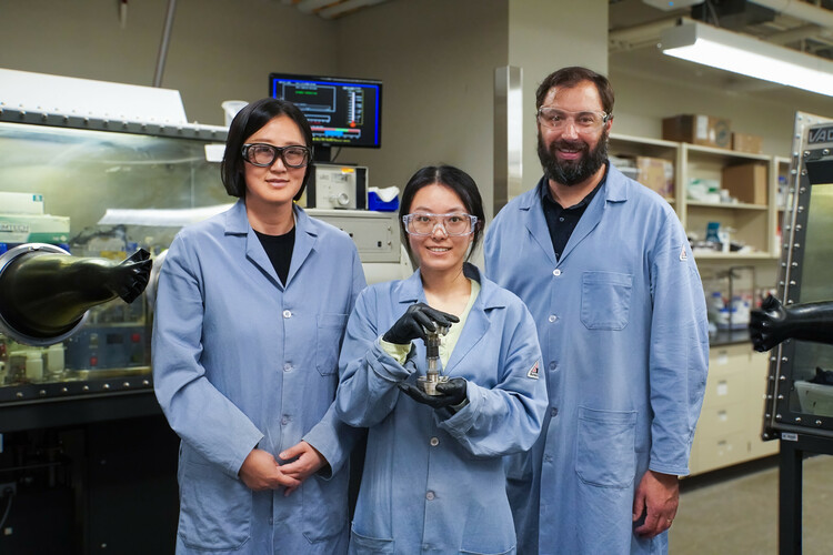 L-R: Dr. Lingzi Sang, Runqi Wu, and .Runqi holding a conflat-style cell, a device that can measure the creep deformation of a solid-state battery composed of the composite electrolyte.