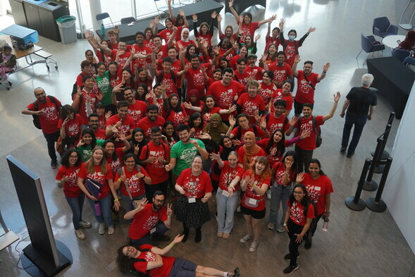 A group of people gathered for a photo in a lobby
