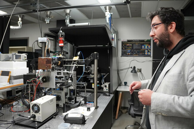 Dr. Gholipour next to lab equipment