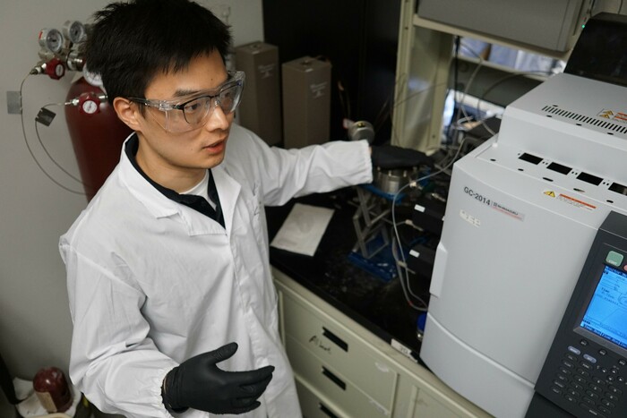 Doctoral student Sheng Zeng explains how their catalyst converts CO<sub>2</sub> into more useful products.