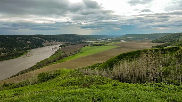 A verdant valley, with river on left of photo. 